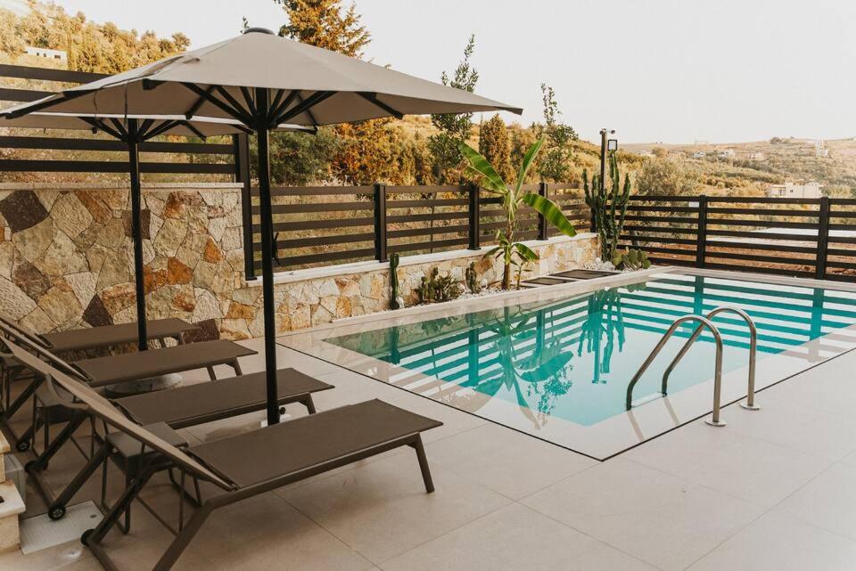 The pool at Vila Luar with two loungers and a parasol